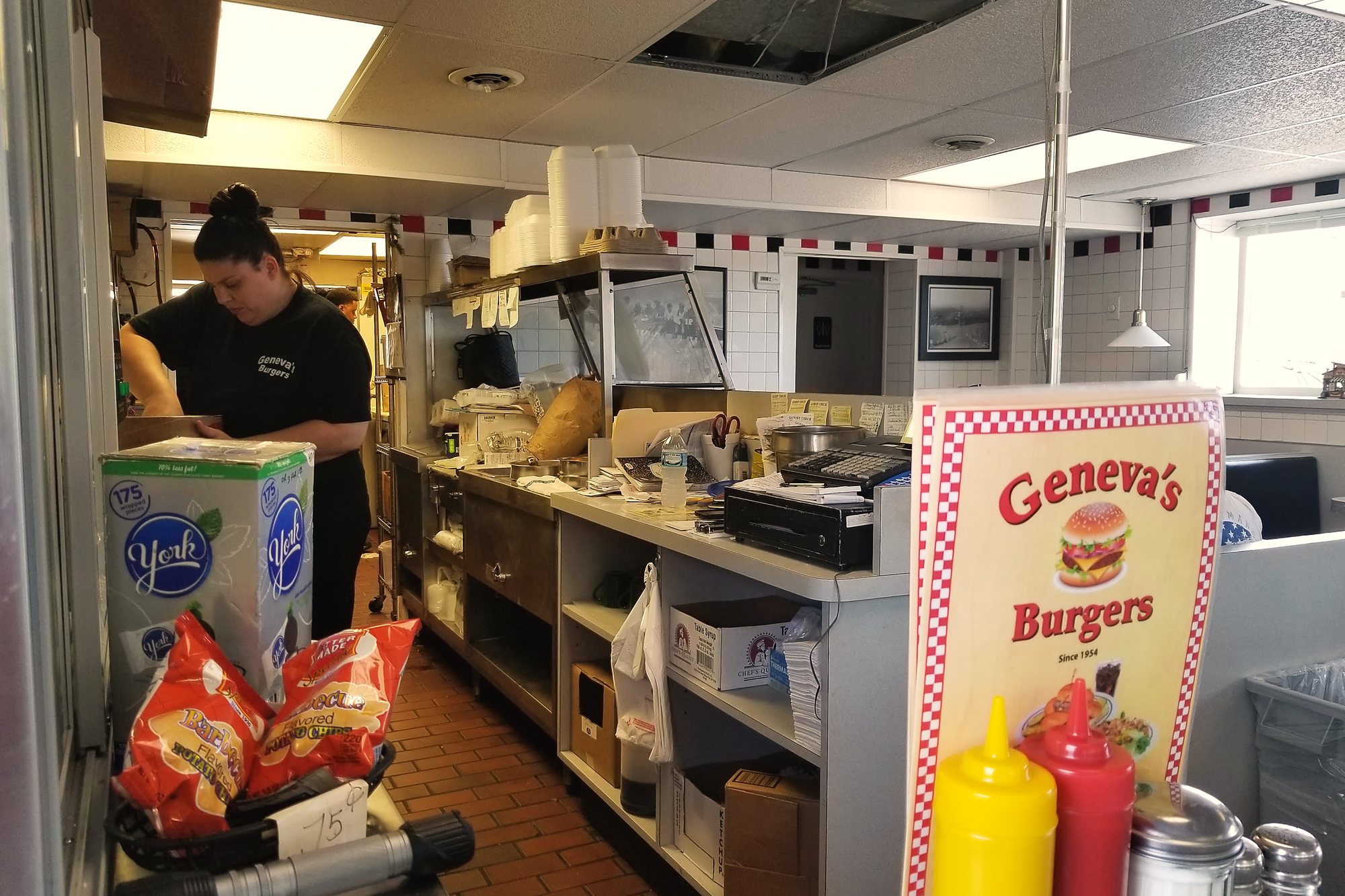 A cook working behind the counter at Geneva's.